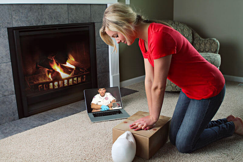 Woman Practicing CPR On Manikin Blended CPR Course